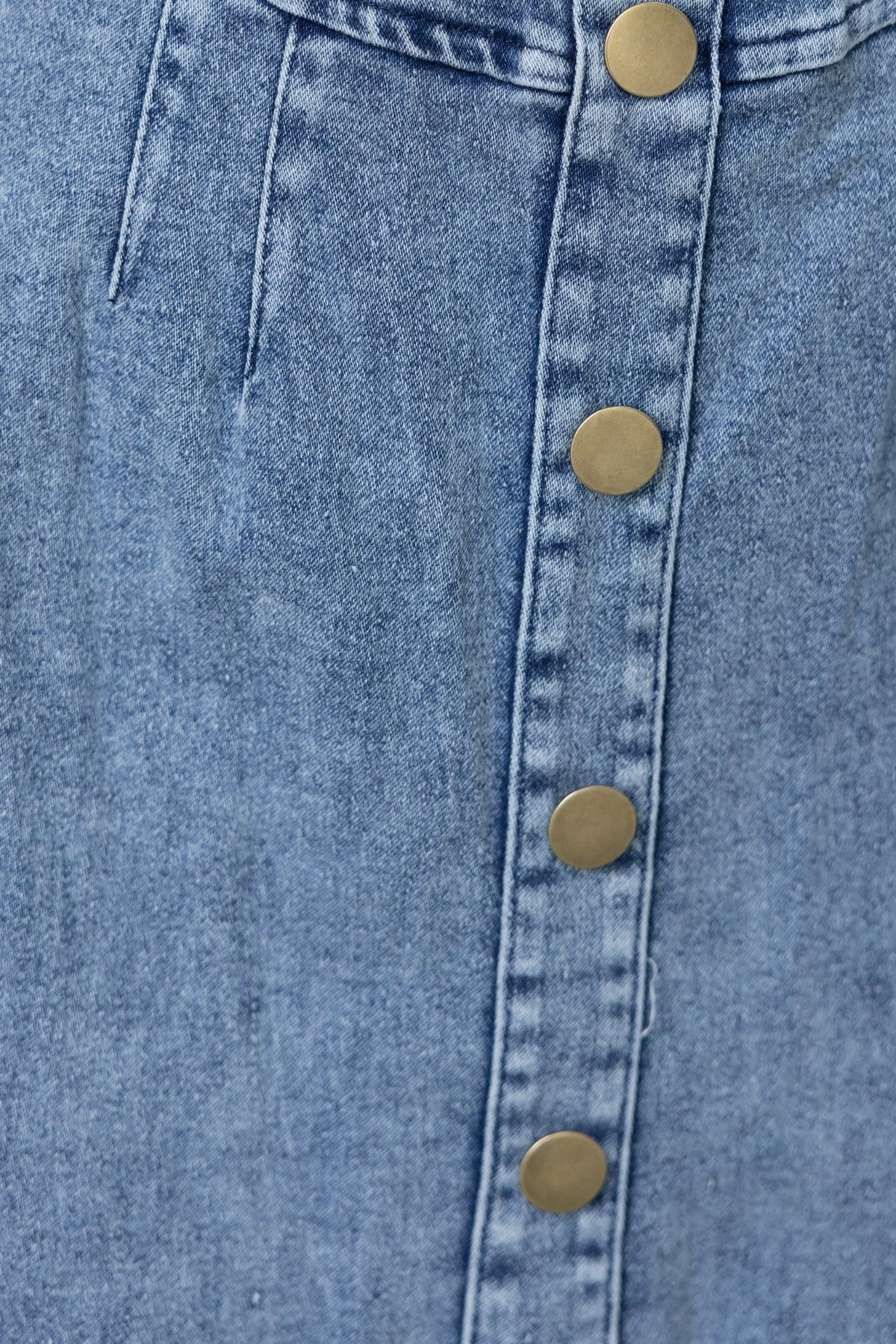 Close-up of Brinna denim midi dress showcasing button detail and fabric texture.