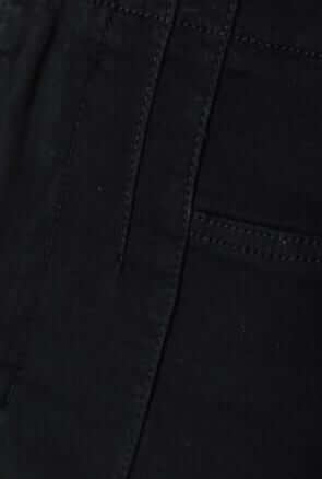 Close-up of Okara black denim jeans showcasing mid-high waist fit and faux pockets.