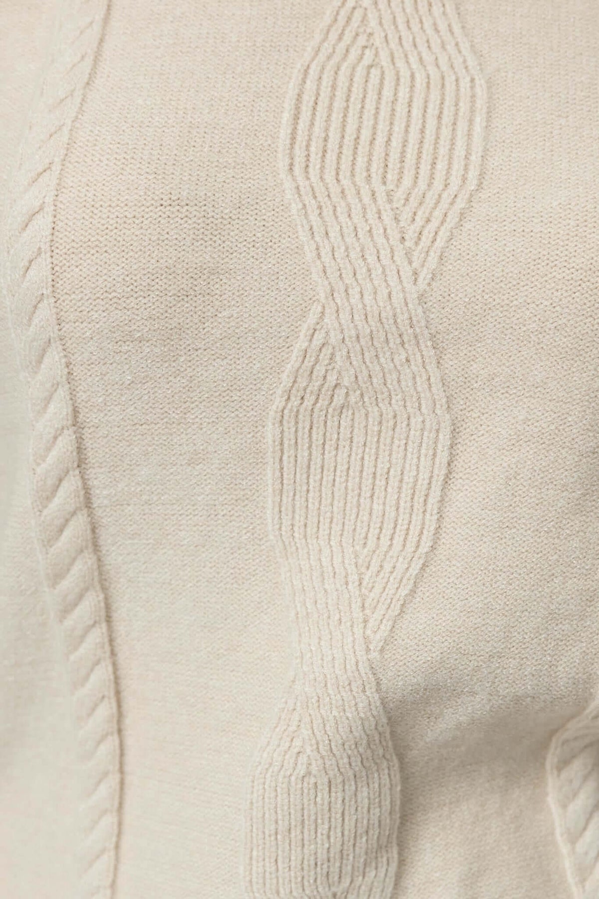 Close-up of Beasley Dress showing the detailed cable knit pattern on soft cream fabric.