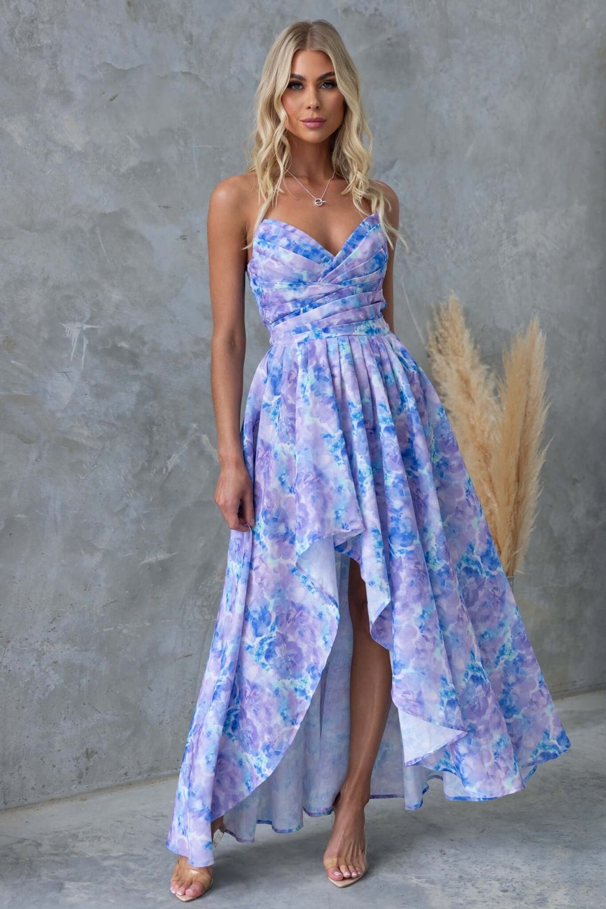 Kiss And Tell Maxi Dress in blue floral print, strapless with asymmetric hem and boning, perfect for summer outings.