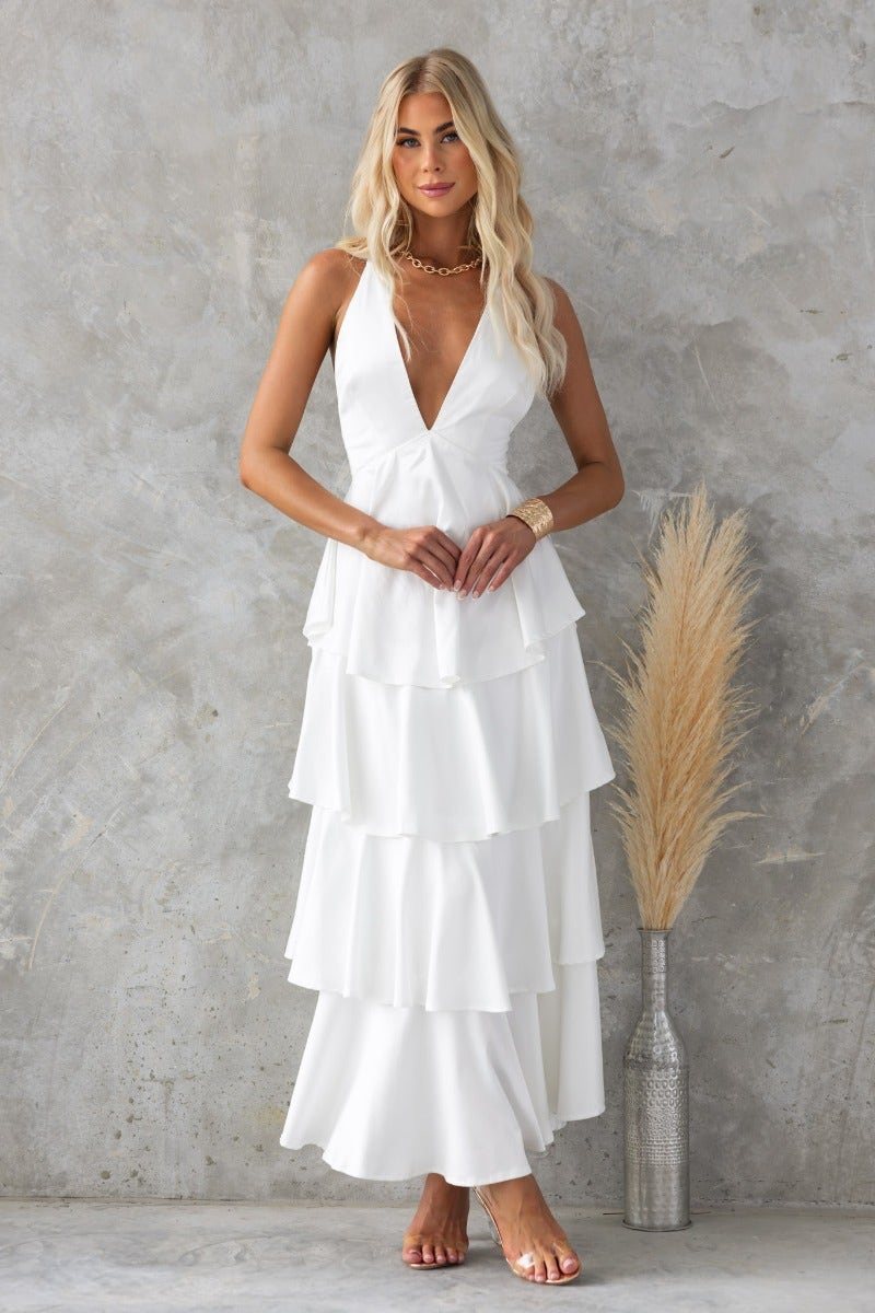 Elegant End Of Time maxi dress with V-neckline and tiered ruffle skirt, paired with stylish accessories.