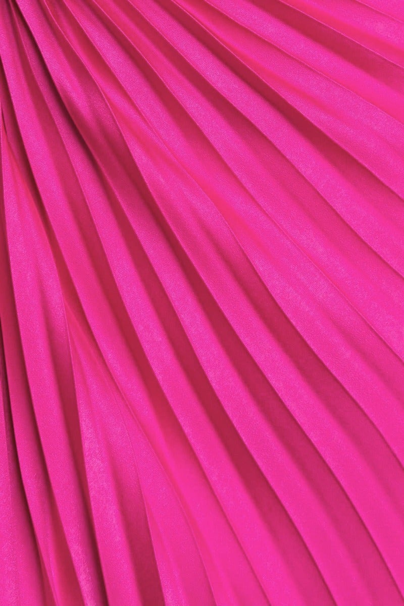 Close-up of accordion pleat fabric in vibrant pink color, ideal for stylish maxi dresses and evening wear.
