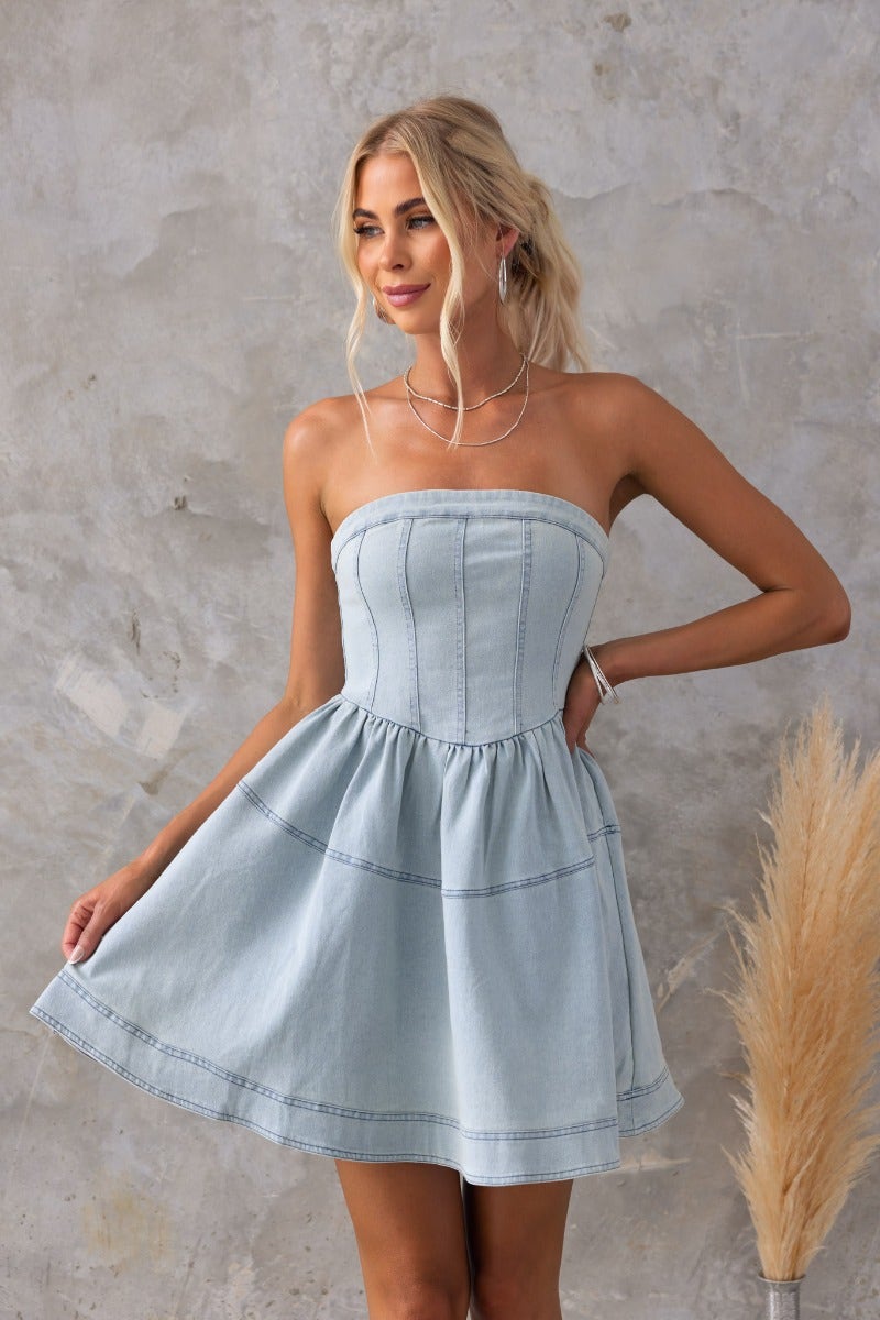 Strapless Never Again Denim Dress in light blue, featuring a flared skirt and zip back detail, perfect for summer outings.
