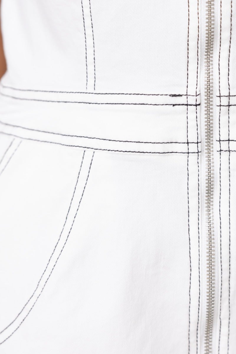 Close-up of the Lytton Playsuit's zip-up front and pocket details, showcasing premium denim texture and stitching.