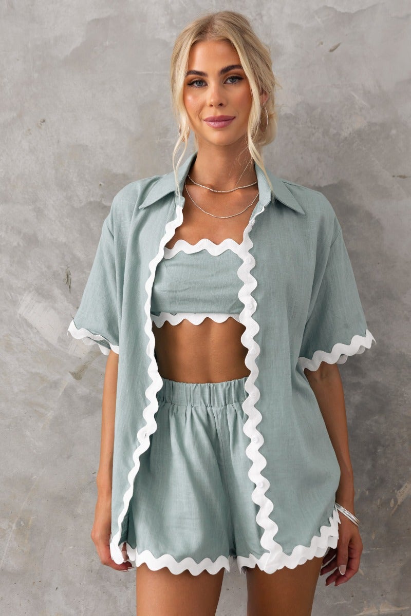 Model wearing Take It Easy Shirt in soft blue with scalloped edges, styled with matching shorts.