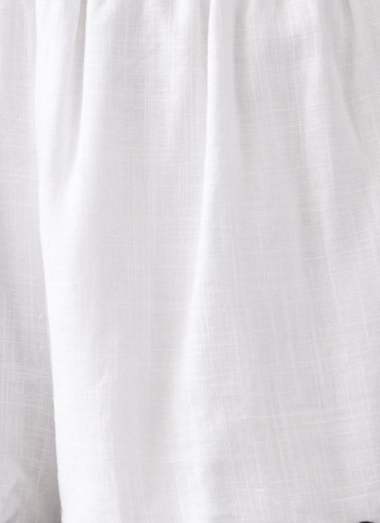 Close-up of the white linen-like fabric of the Take It Easy Shirt, showcasing its soft texture and relaxed fit.