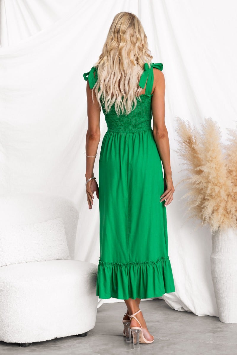 Back view of Qaniva Midi Dress in green with adjustable tie straps and ruffled hem.