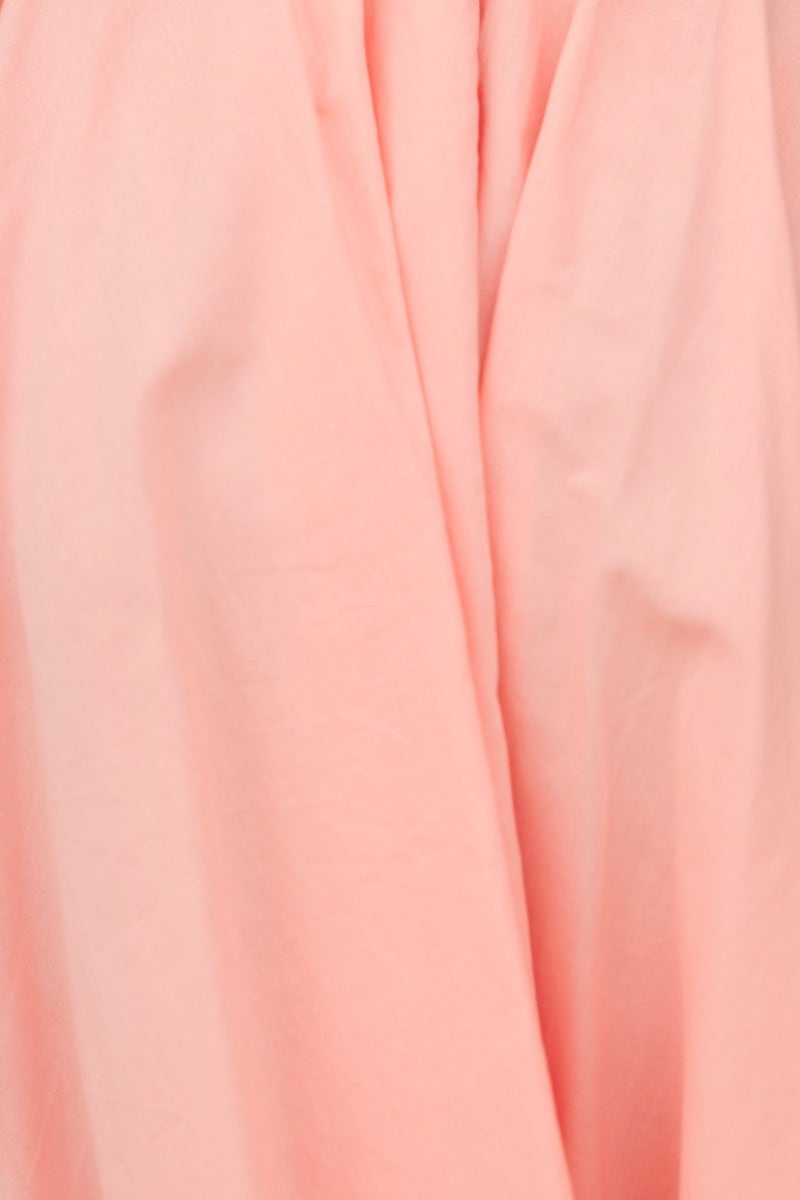 Close-up of soft peach fabric showcasing the texture of the Heart And Soul Dress, designed for comfort and style.