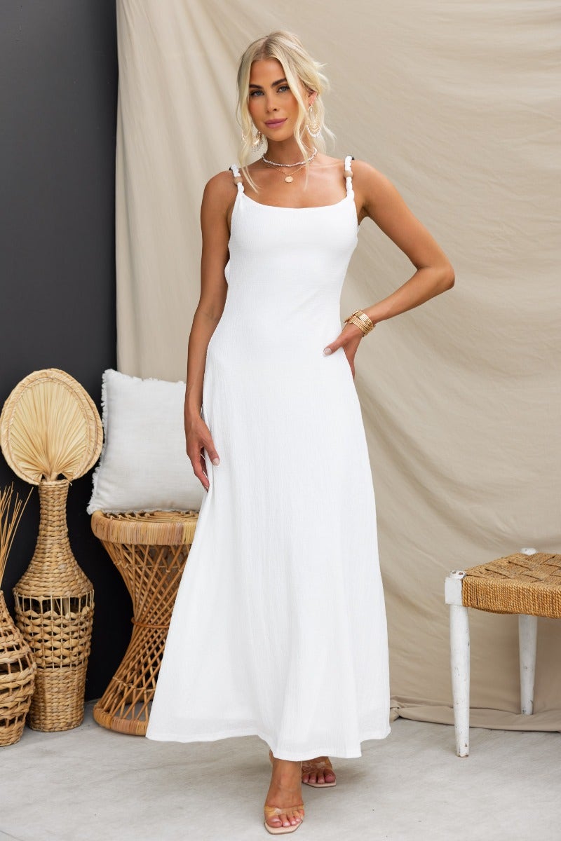 Model wearing a white Ranley Maxi Dress with bead detailing and a lightly textured, stretchy fabric.