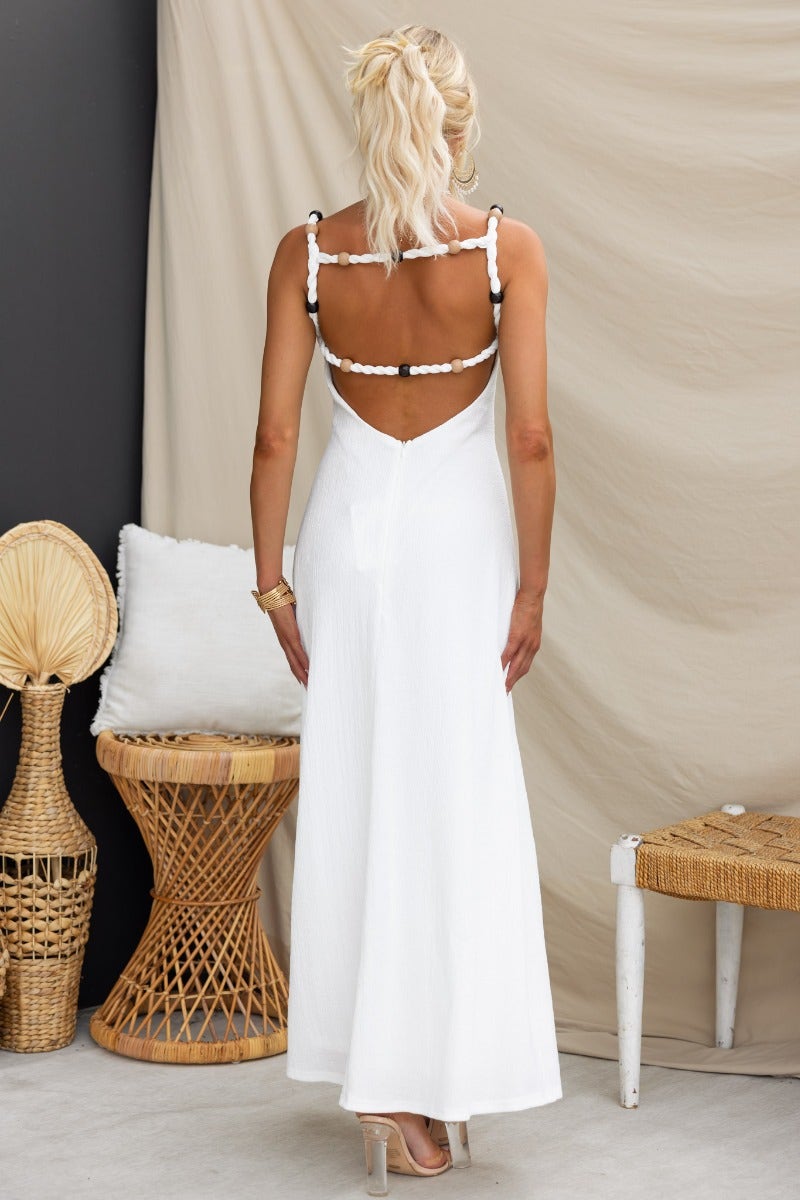 Back view of Ranley Maxi Dress, a white dress with bead detailing at straps and a light, textured fit.