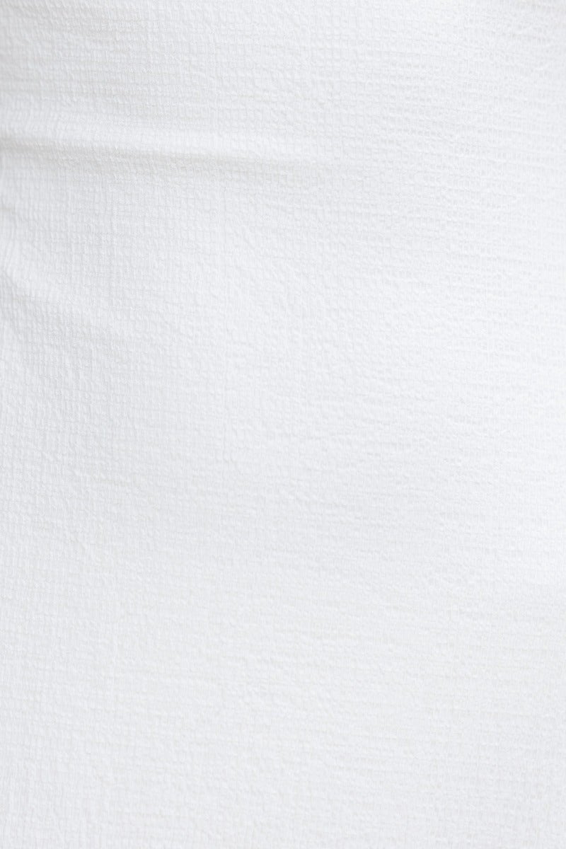 Close-up of lightly textured white fabric of the Ranley Maxi Dress, showcasing its stretch and quality material.