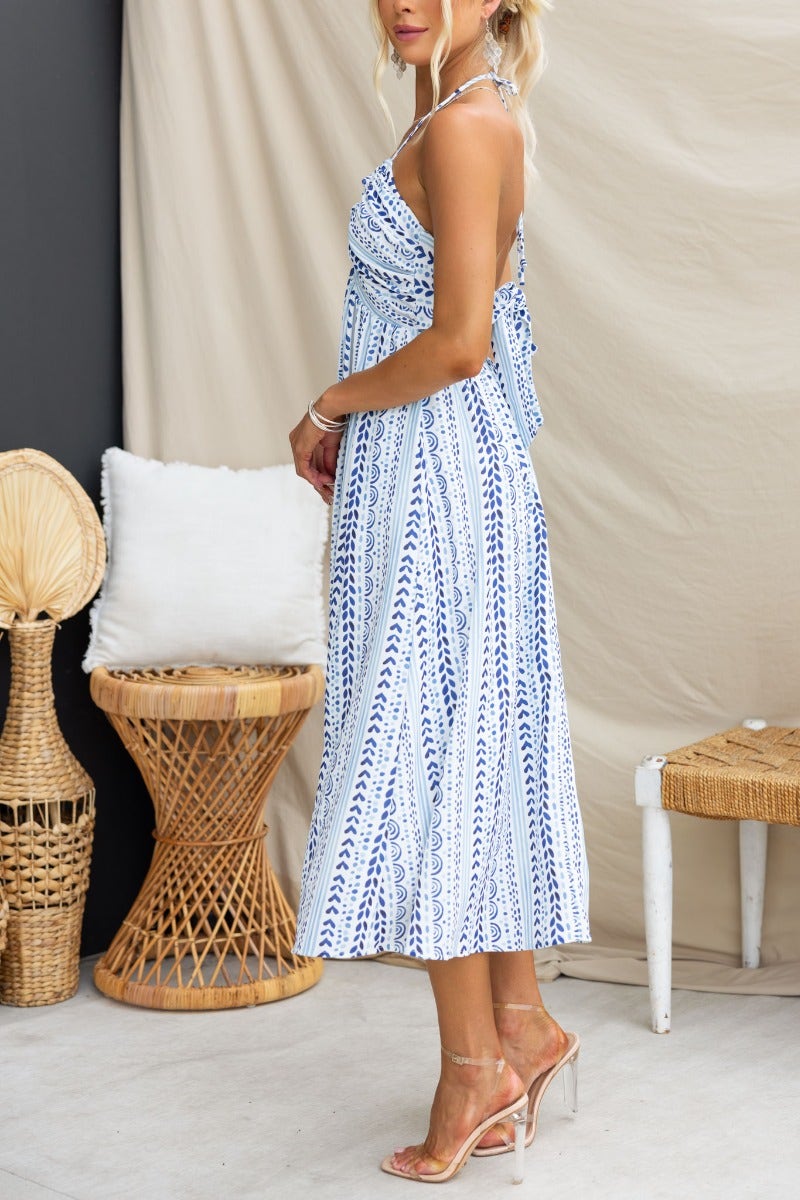 Side view of Qano Midi Dress, featuring abstract print, adjustable tie neckline, and pockets.