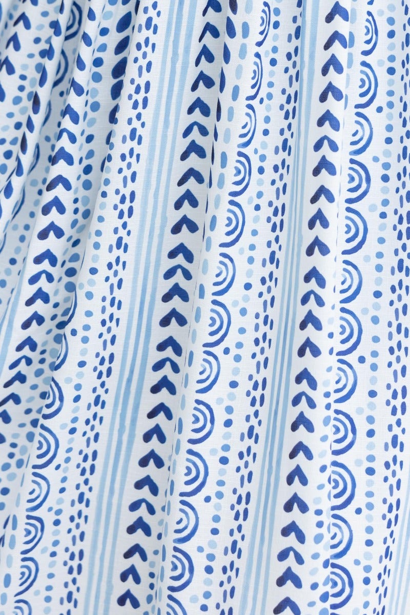 Close-up of abstract print fabric in blue and white featuring hearts and stripes for the Qano Midi Dress.