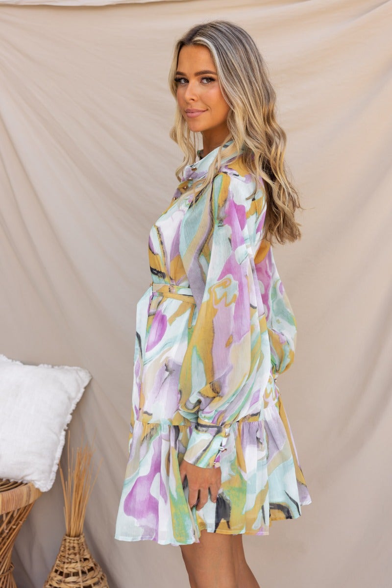Model wearing the Orazio multi-colour print dress with a high neckline and button-up front.