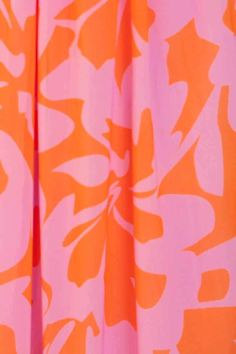 Vibrant floral print fabric of the Marleen Maxi Dress featuring pink and orange hues.