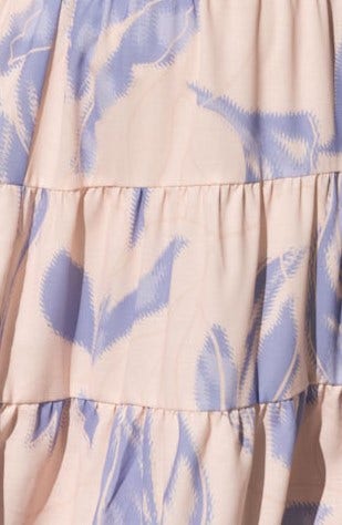 Close-up of Orchi Midi Dress fabric featuring soft blue and blush pattern with tiered ruffles, ideal for casual summer style.