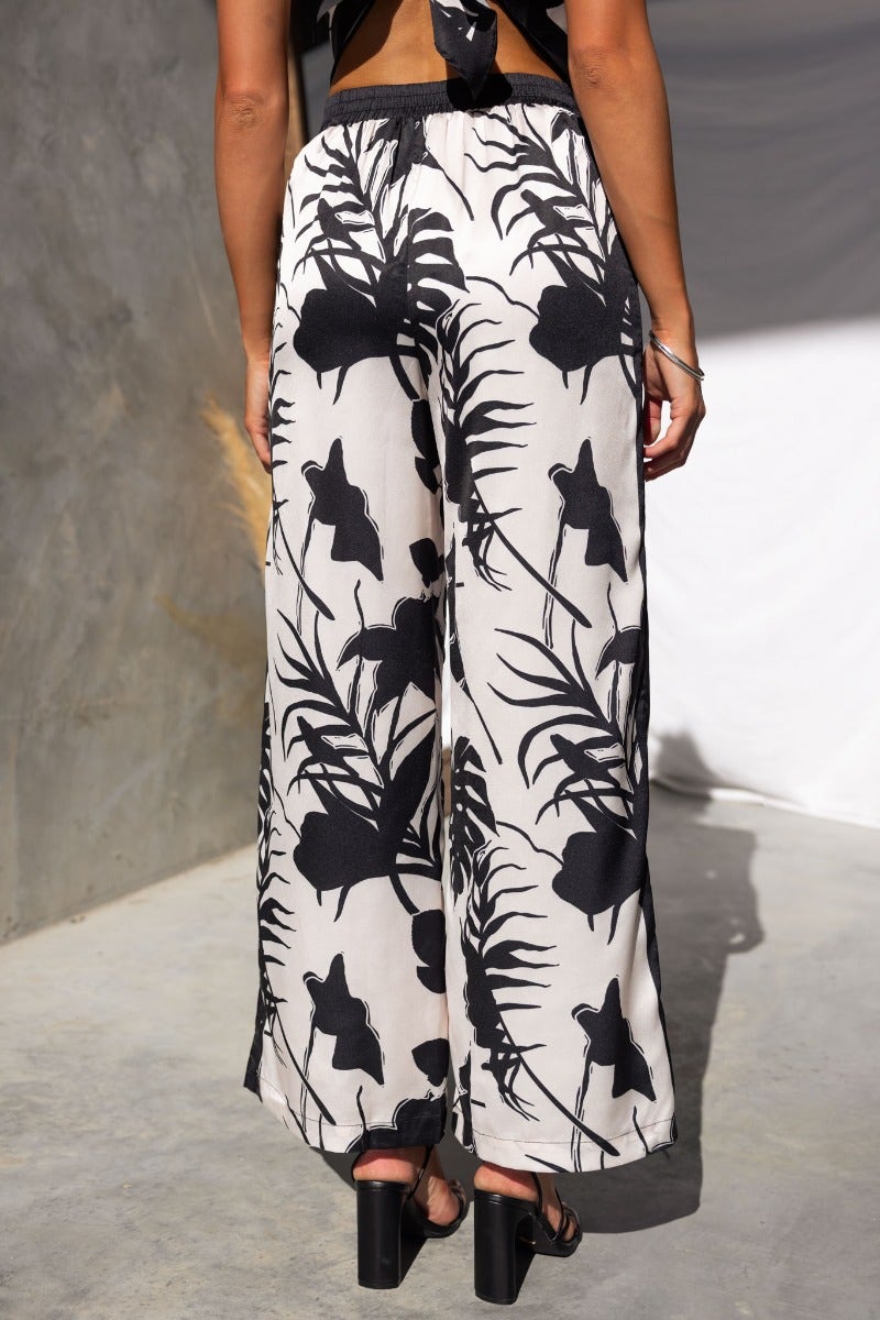 Back view of Persia Pants, featuring a floral pattern, elastic waistband, and wide-leg design, perfect for stylish comfort.