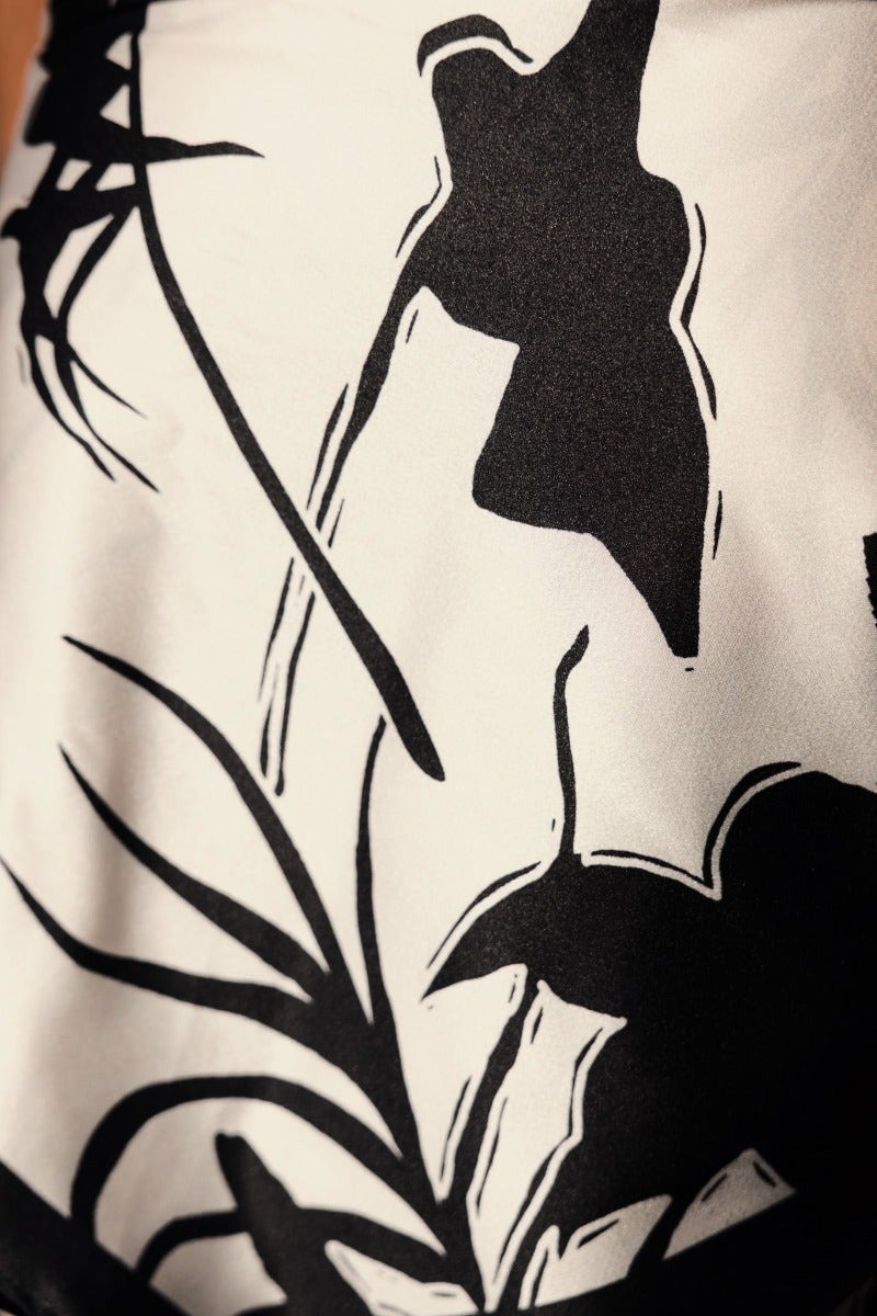 Close-up of black and white floral pattern on satin fabric for Persia Pants.