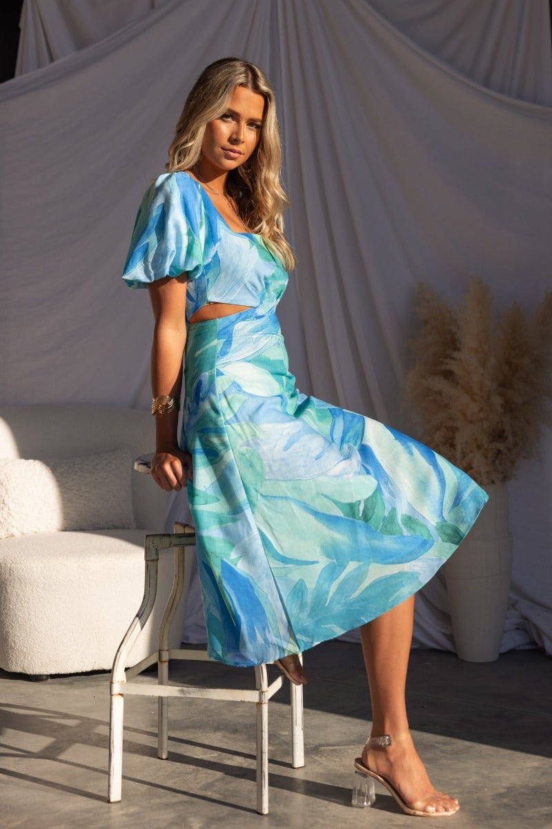 Model wearing the Ayla Midi Dress, featuring a multi-colour design, square neckline, and cut-out waist detail.