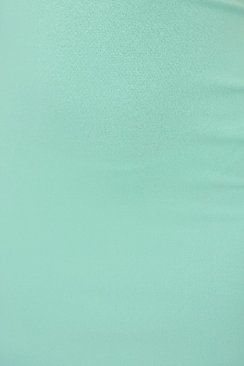 Close-up of mint green fabric with smooth texture, perfect for a Claira Maxi Dress.