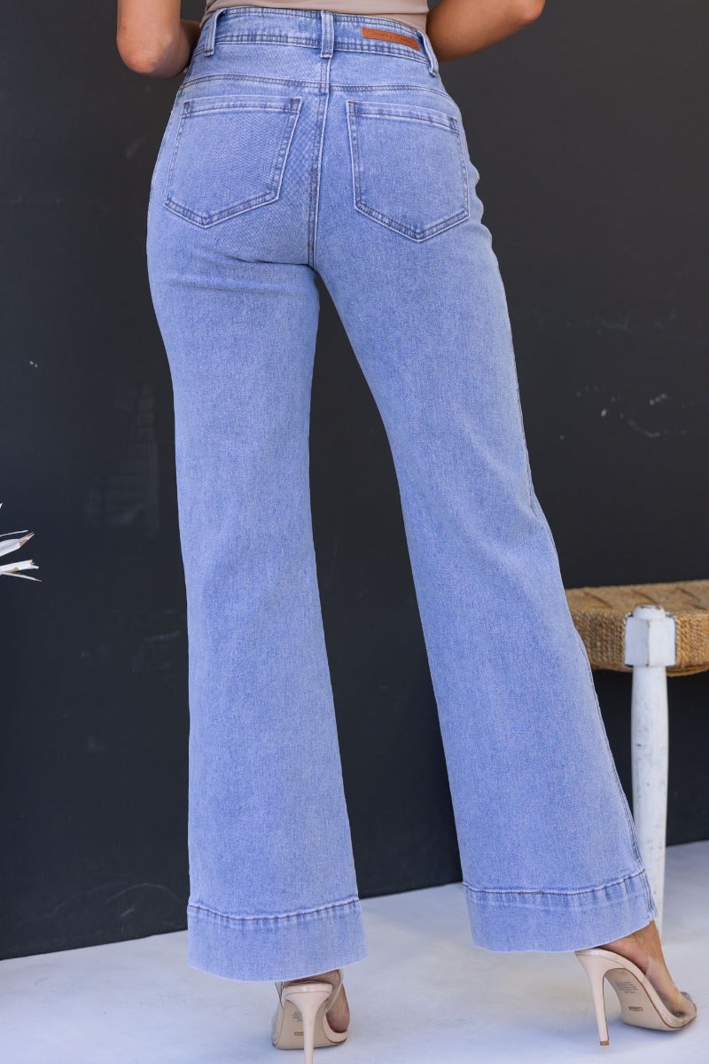 Back view of women wearing light blue Lane Jeans with a mid-high waist and flared leg style.