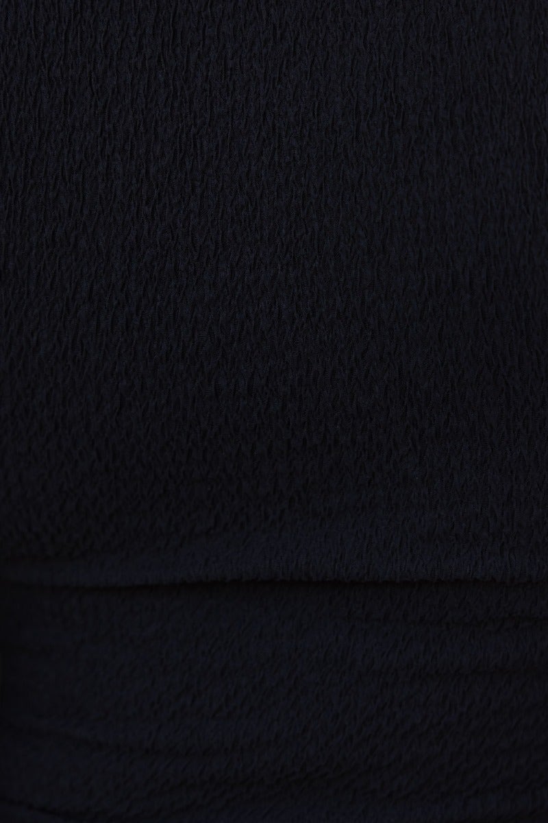 Close-up of black textured material suitable for the Darby Bodysuit, showcasing its stretch and elegant design.