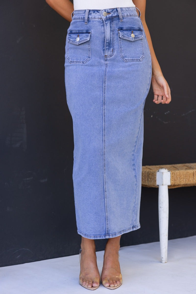 Mora Denim Midi Skirt featuring a mid-high waist, front and back pockets, and a stylish back split.