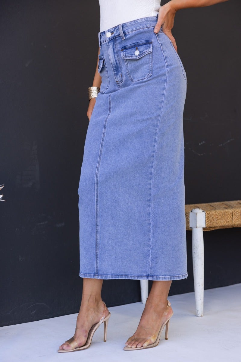 Mora Denim Midi Skirt with mid-high waist, front and back pockets, and back split, showcased on model.