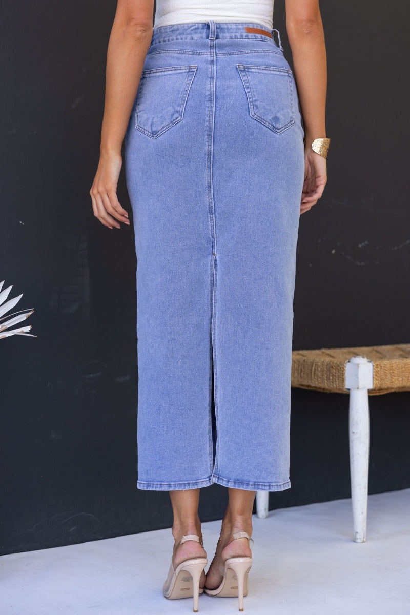 Back view of Mora Denim Midi Skirt showing mid-high waist, split detail, and front and back pockets.