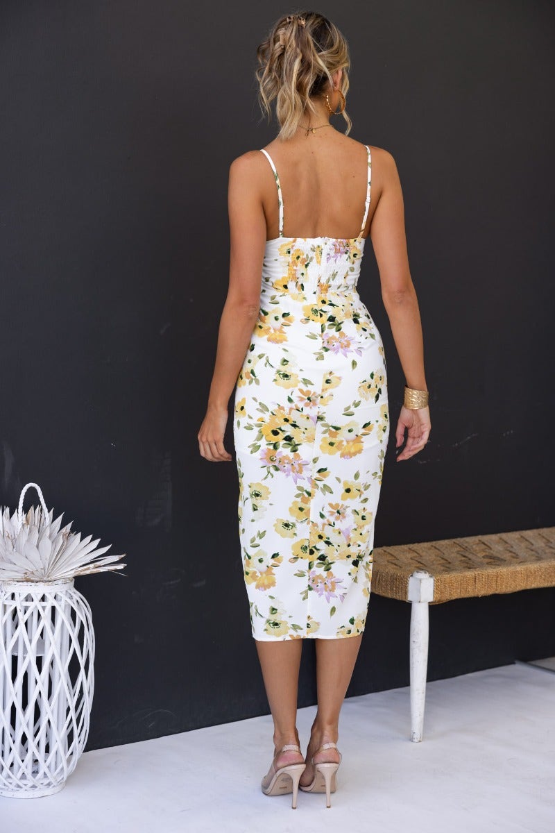 Back view of the Zephyr Midi Dress featuring floral print, adjustable straps, and ruched detailing.