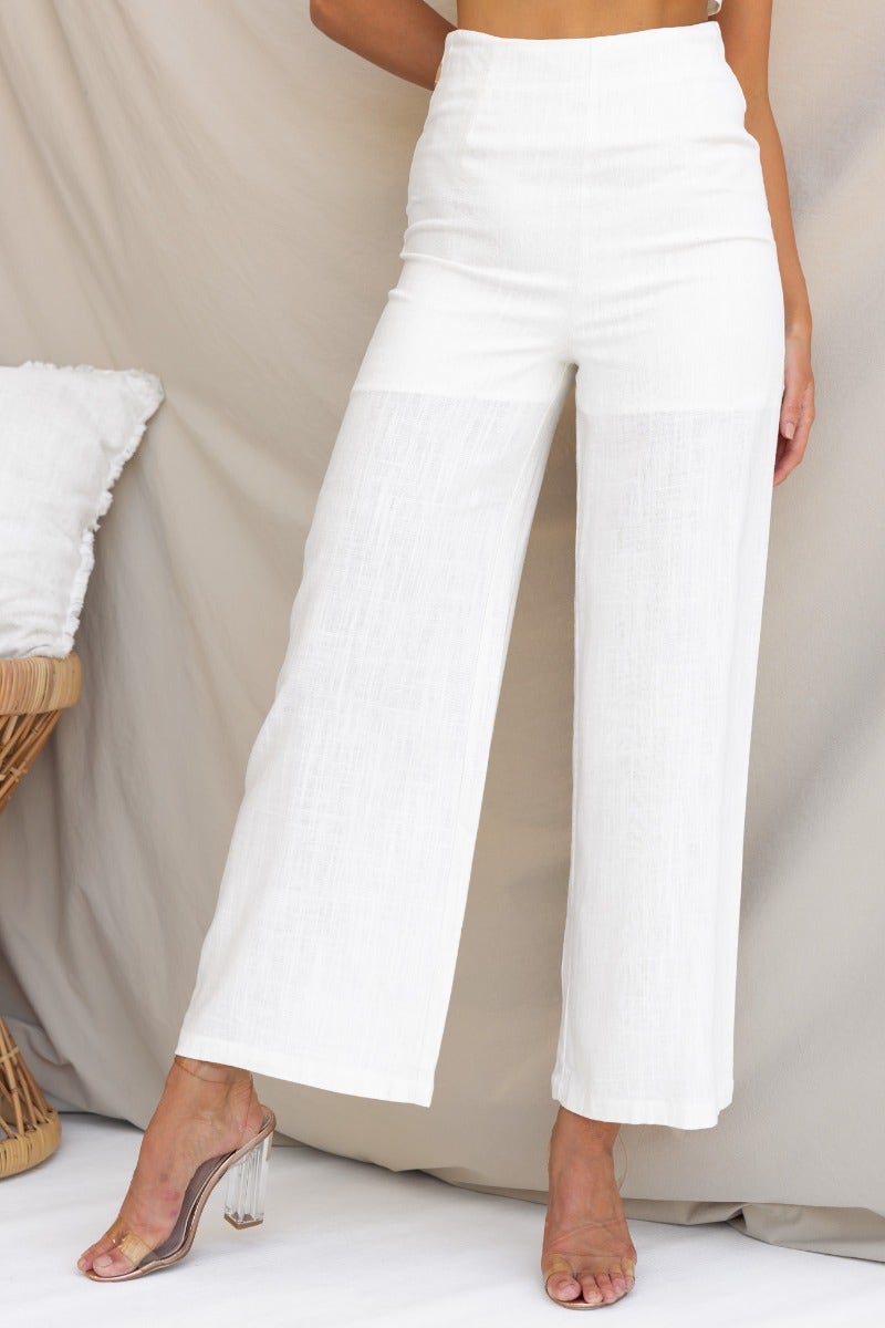 White linen blend Reed Pants with mid-high waist and wide legs, styled elegantly against a neutral backdrop.