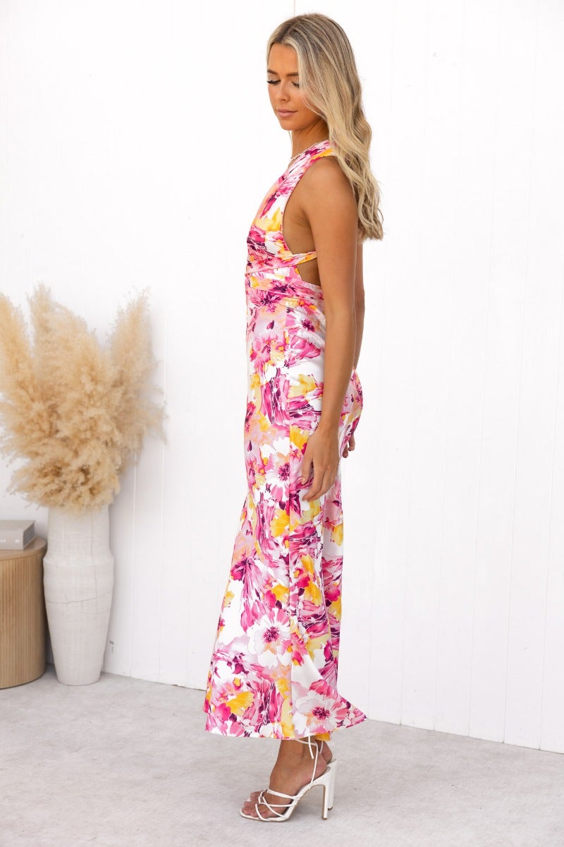 Model in a floral satin maxi dress with a tie halter neckline and side view showcasing its elegant fit.