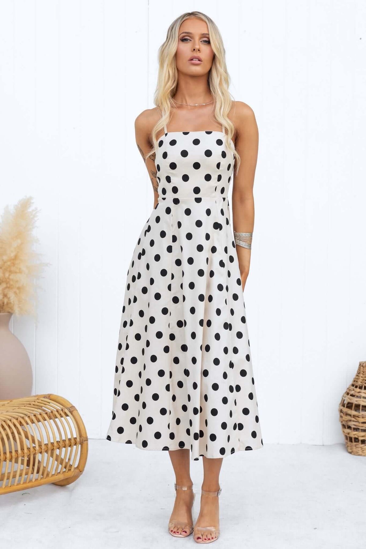 Orphila Midi Dress featuring adjustable straps, square neckline, and a stylish black polka dot pattern on a cream background.