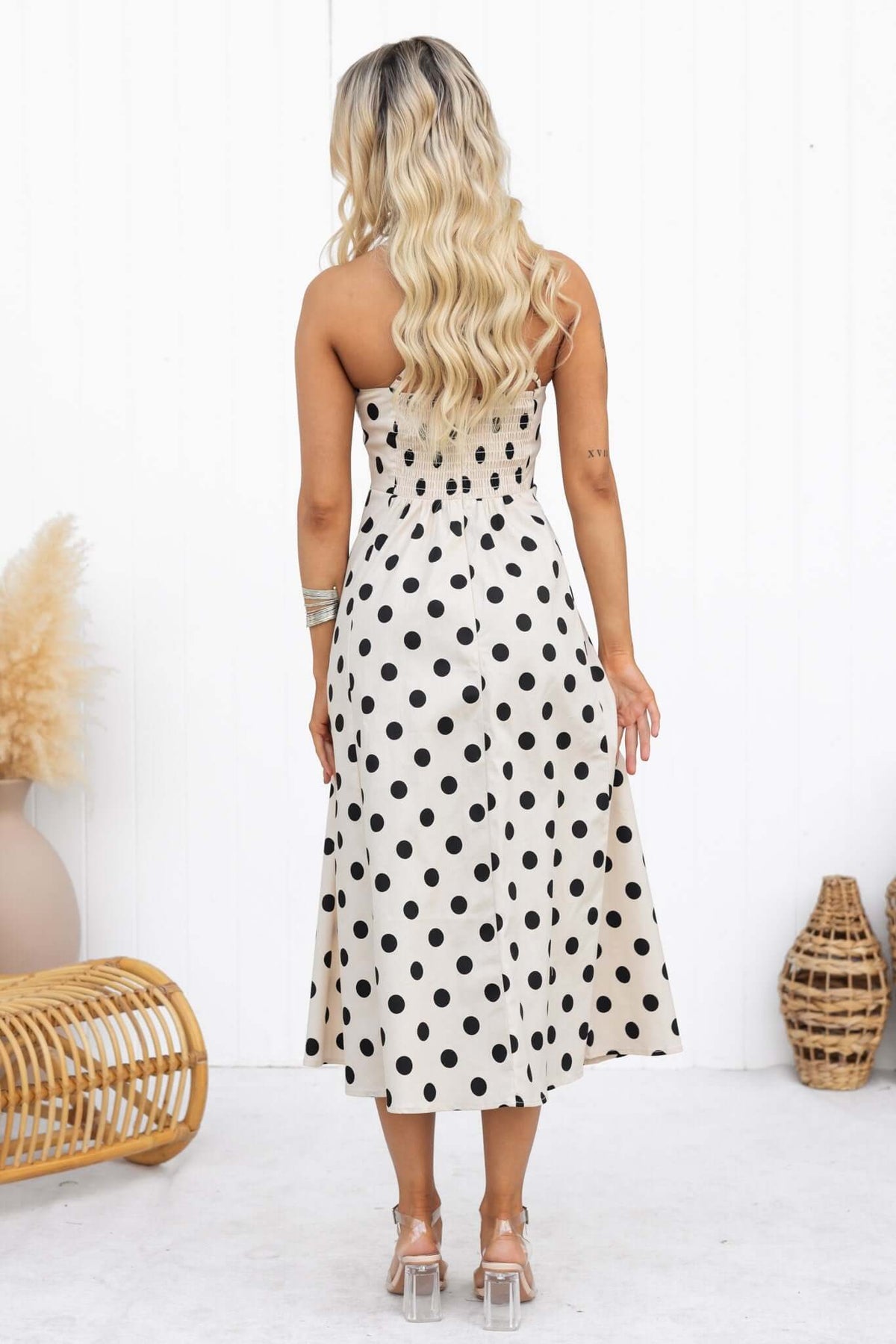 Back view of the Orphila Midi Dress featuring adjustable straps and a polka dot pattern.
