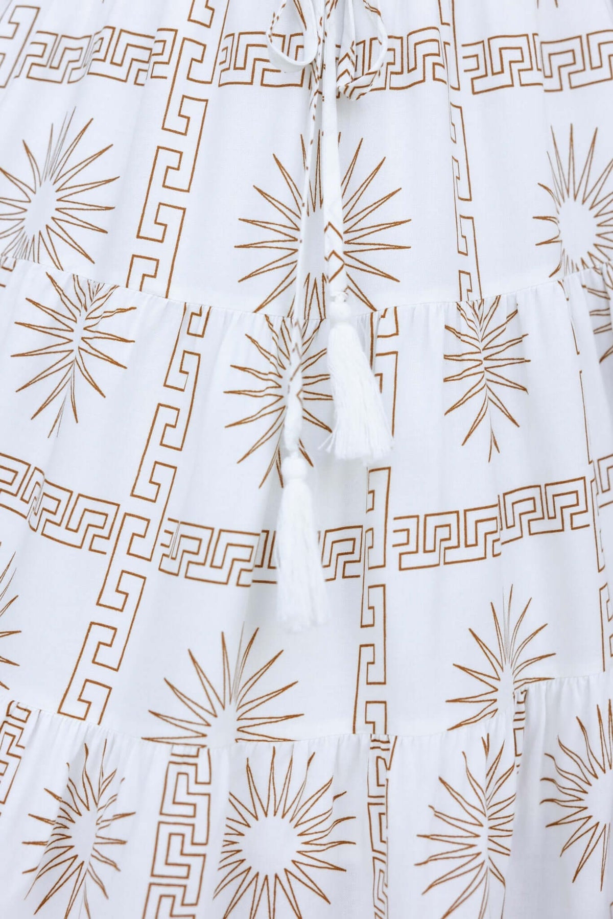 Close-up of the Sun Is Out Dress featuring a patterned design, drawstring tie, and soft cotton feel fabric.
