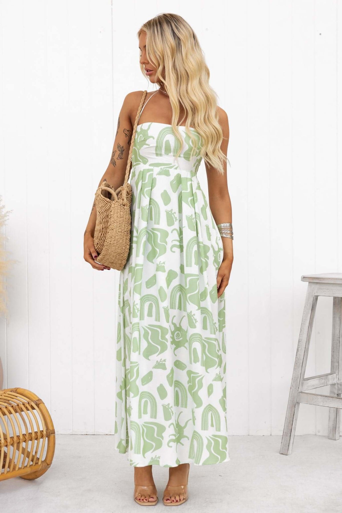 Derry Maxi Dress in green print, featuring adjustable straps, square neckline, and flowing silhouette.
