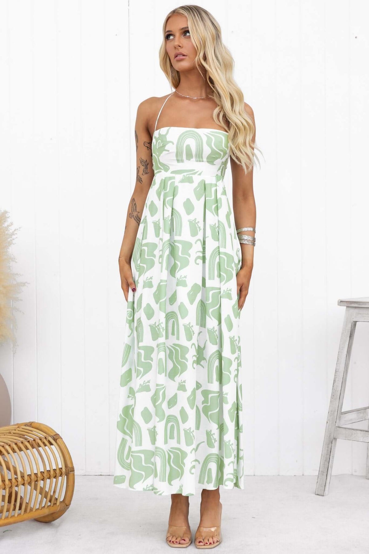 Model wearing a green patterned Derry Maxi Dress with adjustable straps and a square neckline.