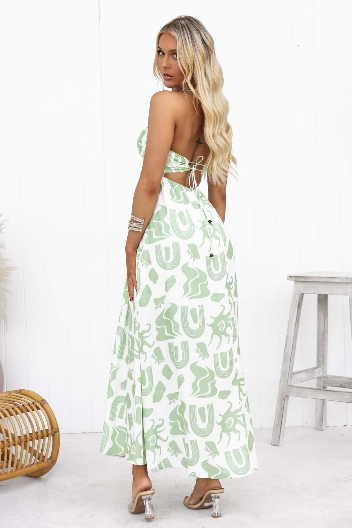 Elegant Derry Maxi Dress featuring a green print, adjustable tie straps, and a stylish back tie detail.