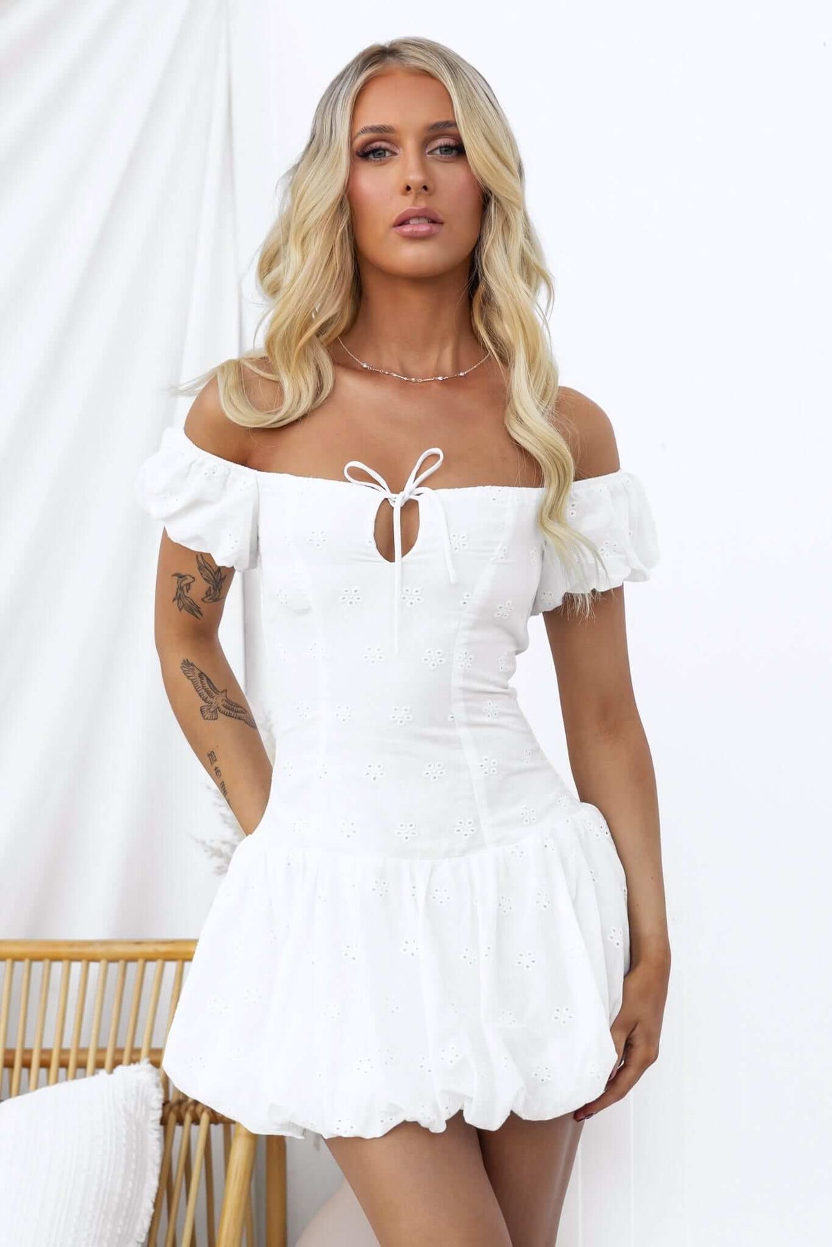 Fairfield Dress in white, featuring a tied bust, elastic sleeves, and a flouncy skirt, perfect for summer occasions.