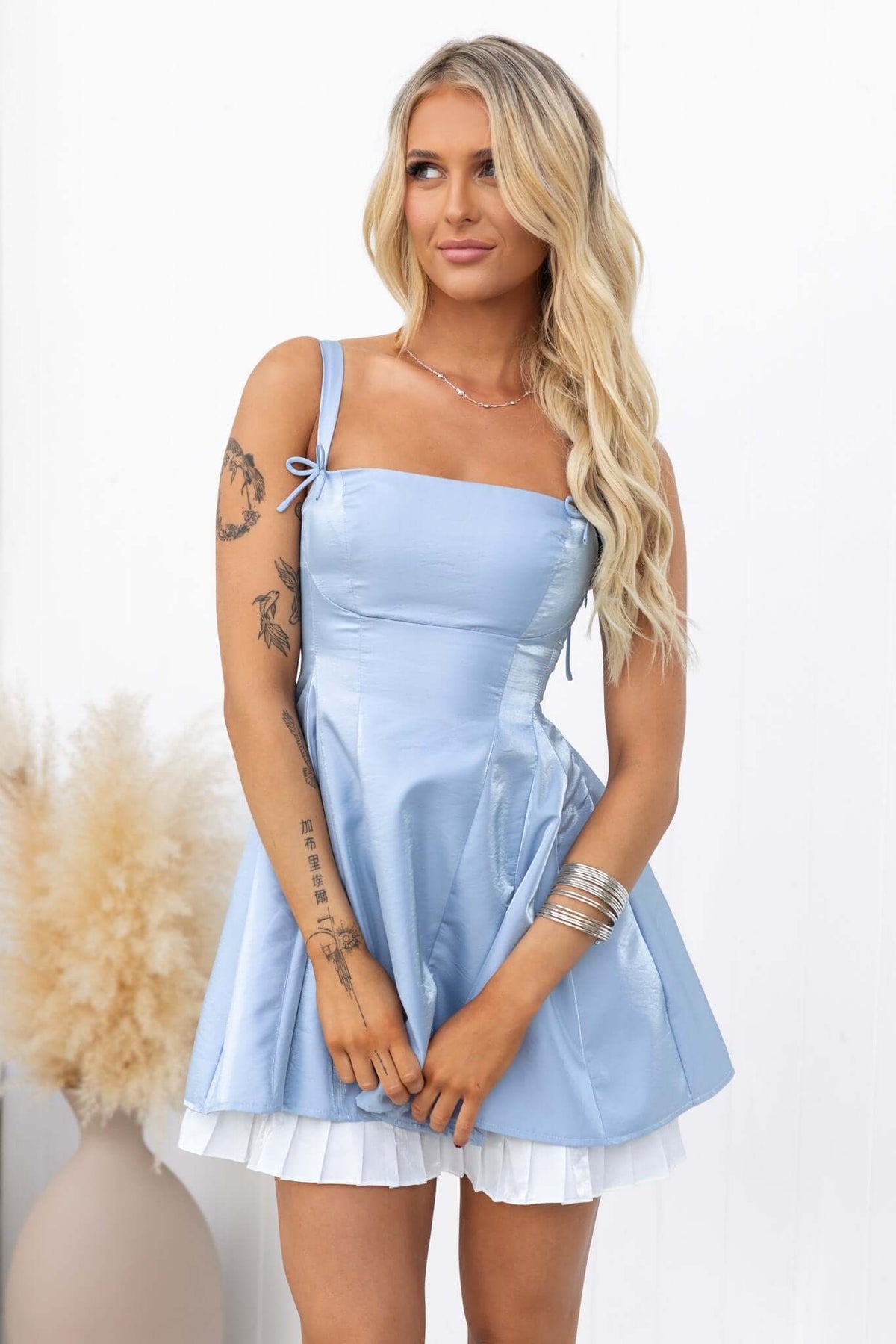 Yalena Mini Dress in light blue with tie straps and fitted bust, perfect for a casual day out.