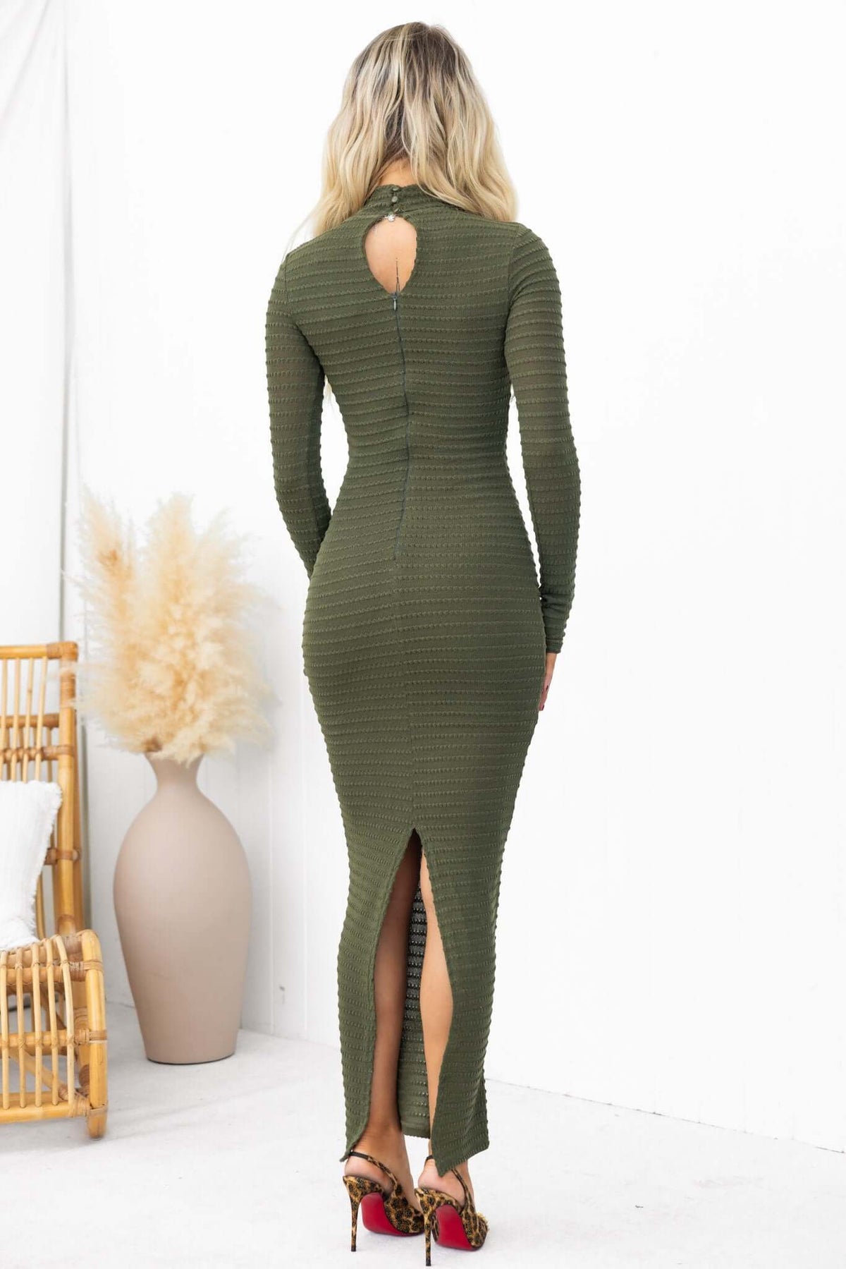 Back view of Everlie Maxi Dress in olive green, featuring a high neckline, split back, and textured stretch material.