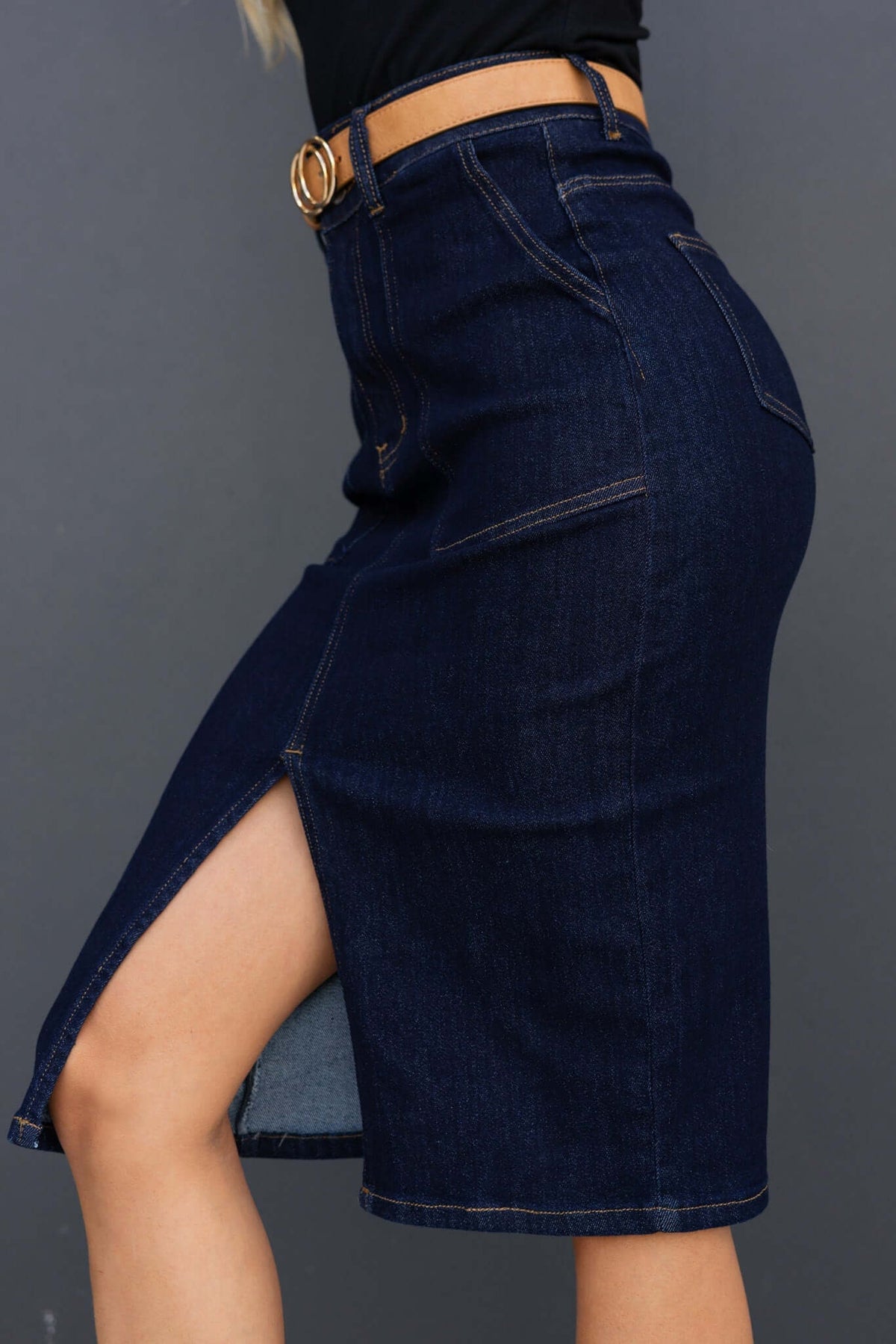 Ella Denim Midi Skirt in dark navy with mid-high waist, front split, and pockets, showcasing a stylish fit.