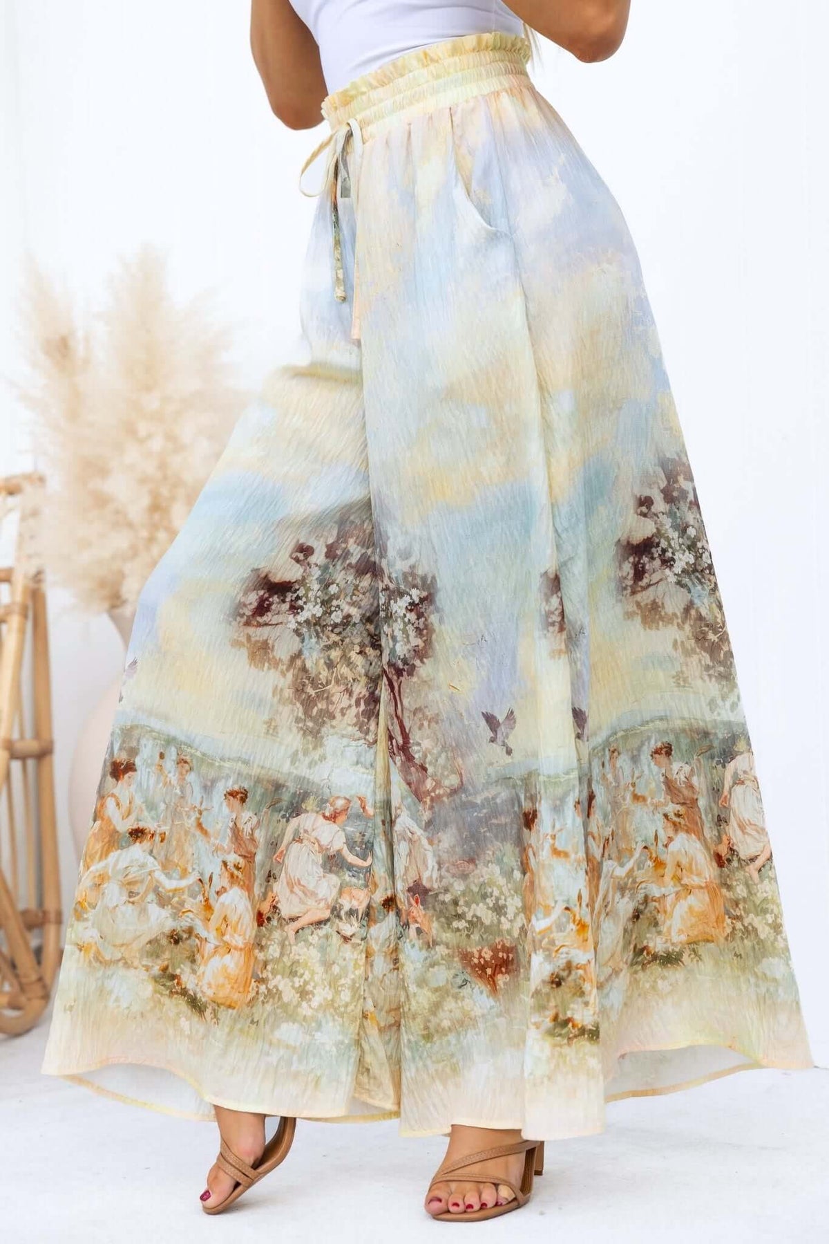 Grafton Pants featuring abstract print, mid-high waist, elastic waistband, and wide legs, styled with a casual top.