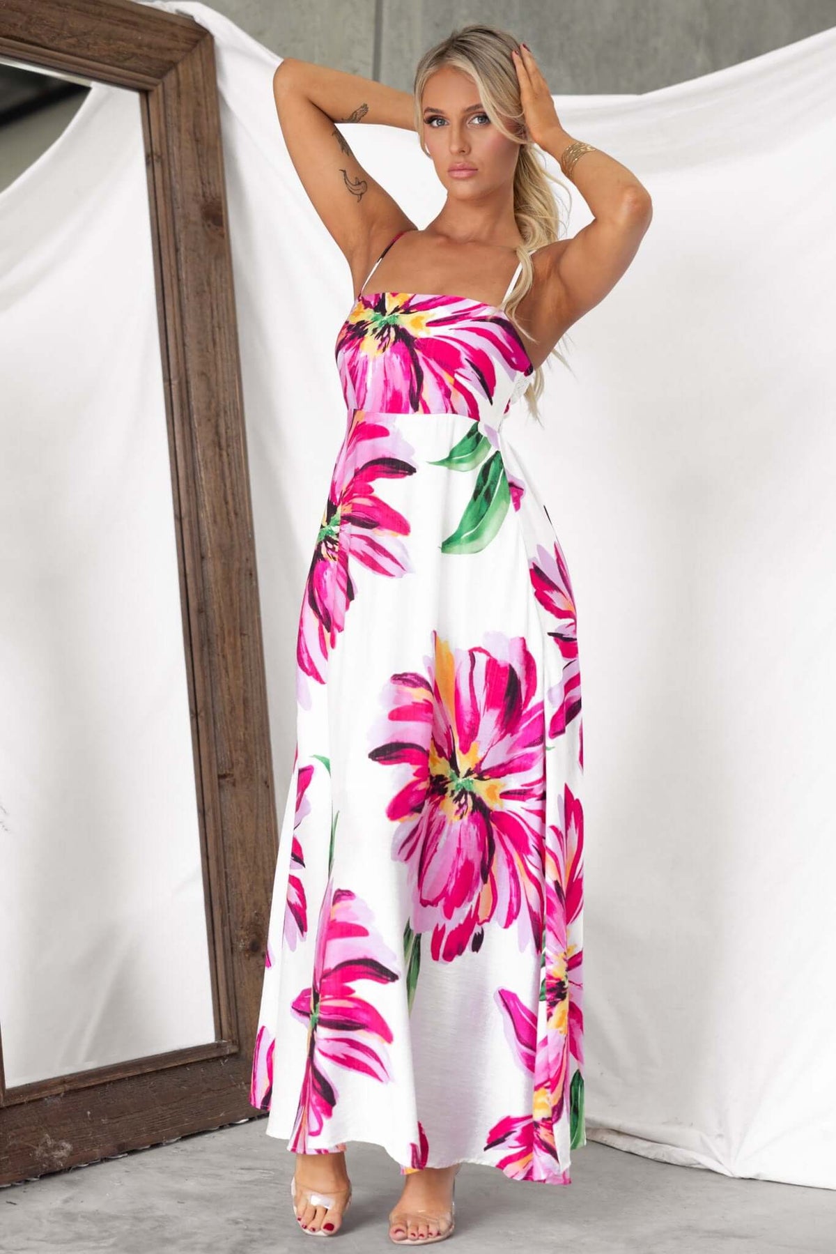 Model wearing Salilah Maxi Dress with floral pattern, featuring thin straps, shirred back, and pockets.