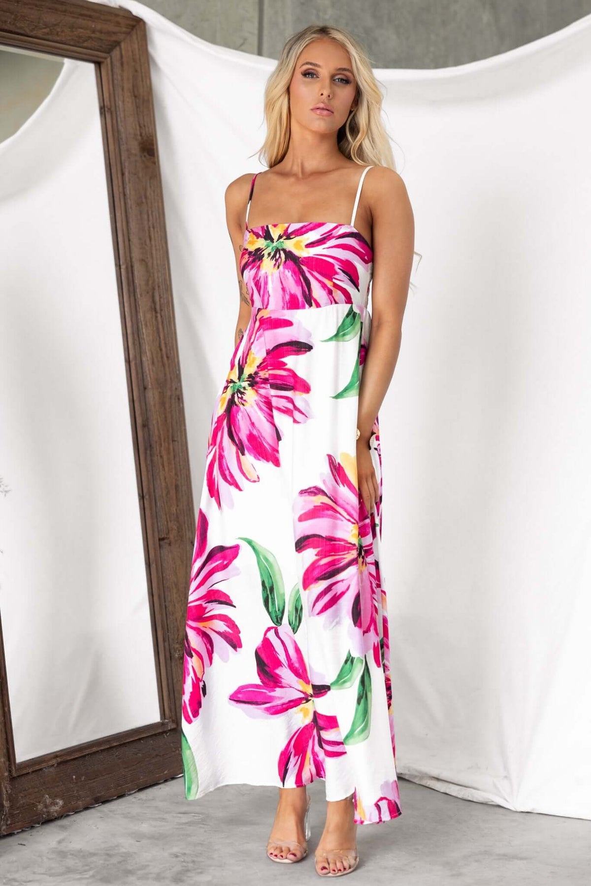 Salilah Maxi Dress featuring vibrant floral print, thin adjustable straps, and pockets, perfect for summer occasions.