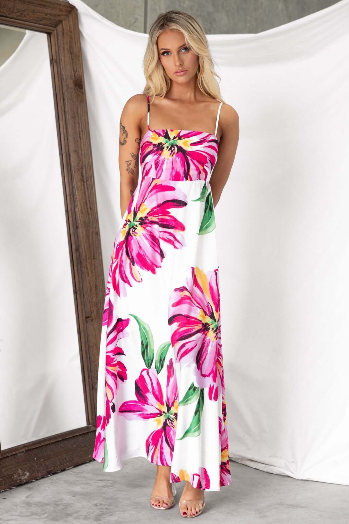 Salilah Maxi Dress with pink floral pattern, featuring adjustable straps and a shirred back, suitable for summer occasions.