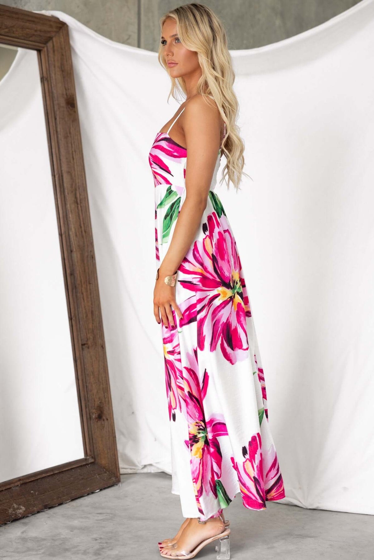 Side view of woman in Salilah Maxi Dress with floral print, featuring thin straps and mid-thigh lining, perfect for warm weather.