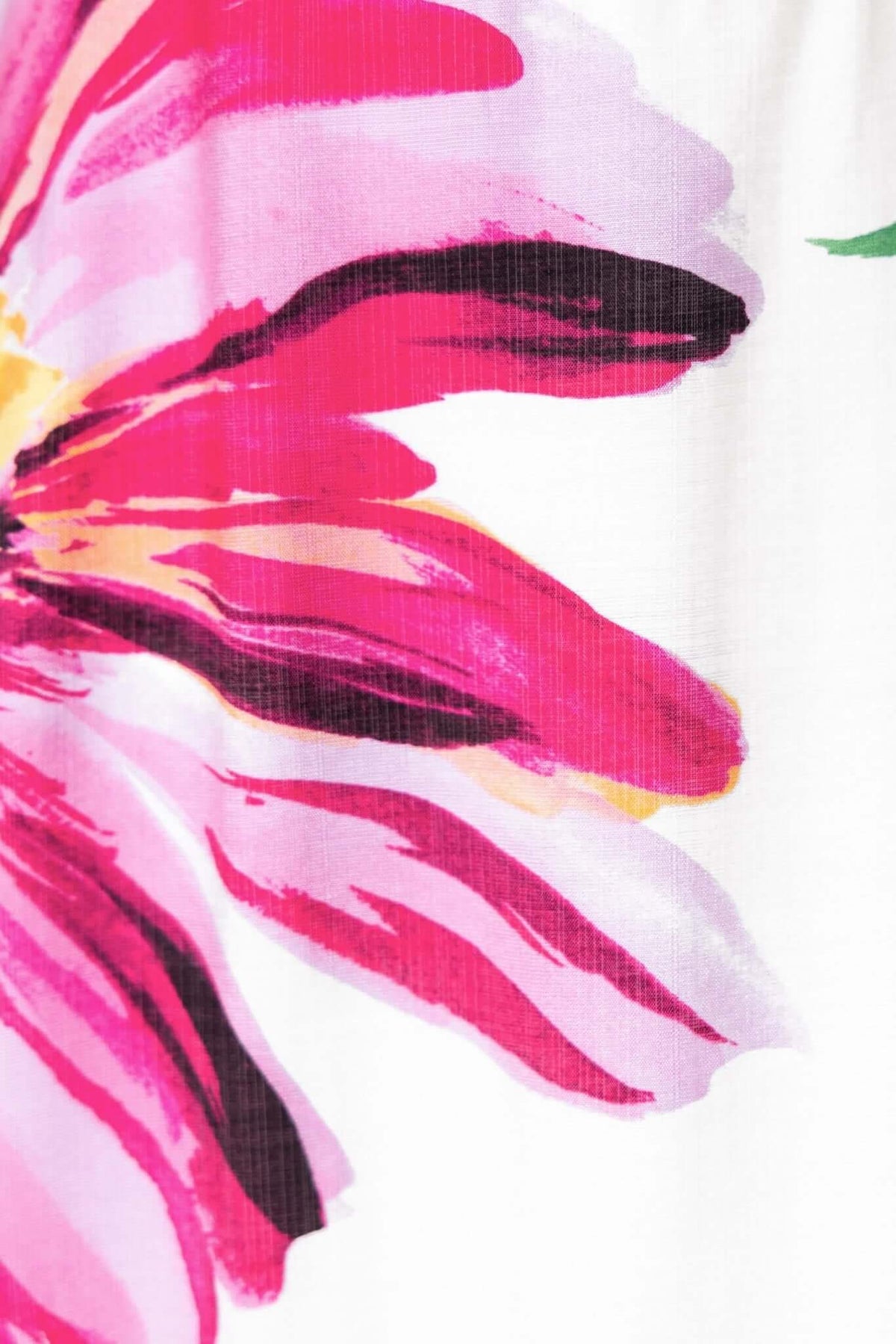 Close-up of vibrant pink floral design on the Salilah Maxi Dress, showcasing bold brush strokes and soft fabric texture.
