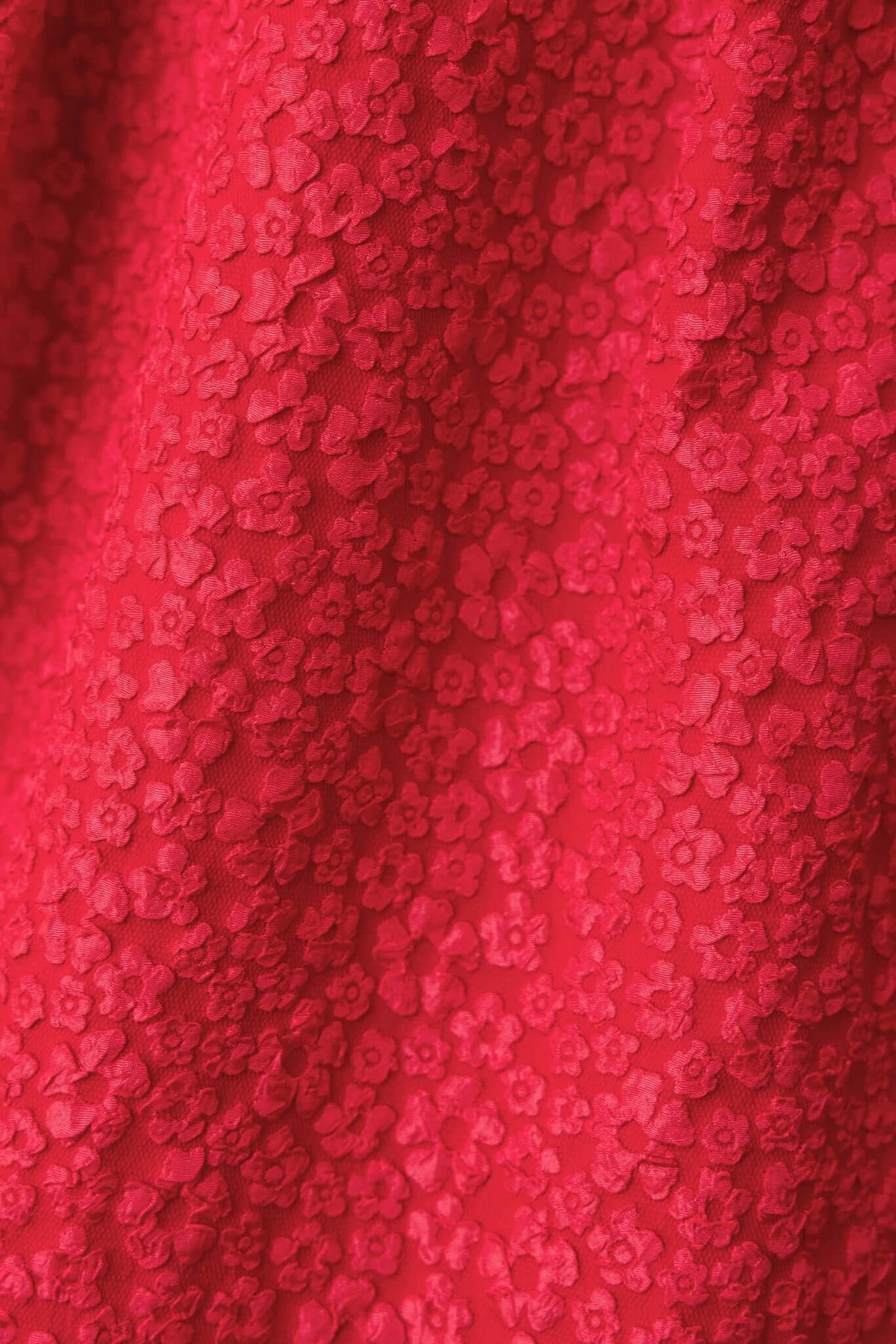 Close-up of textured red fabric with floral pattern, ideal for the Ultima Maxi Dress.