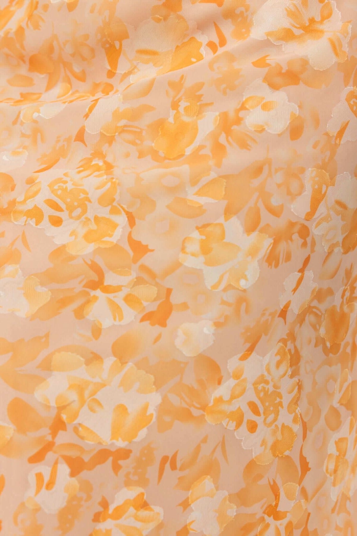 Close-up of floral textured detail in soft orange and cream shades on the Fifth Street Maxi Dress.